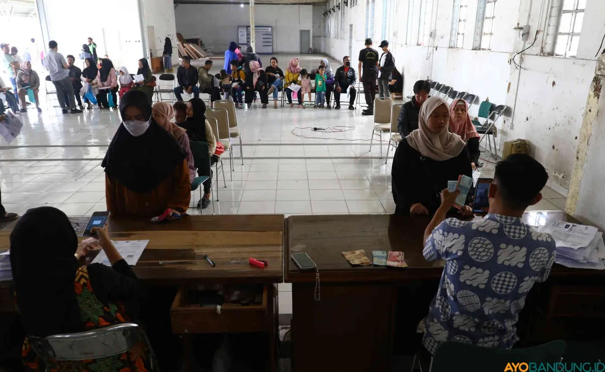 Warga antre untuk menerima bantuan sosial program keluarga harapan (PKH) di Kantor Pos Cabang Utama, Jalan Asia-Afrika, Kota Bandung, Jumat 10 Mei 2024. (Sumber: ayobandung.id | Foto: Irfan Al- Faritsi)