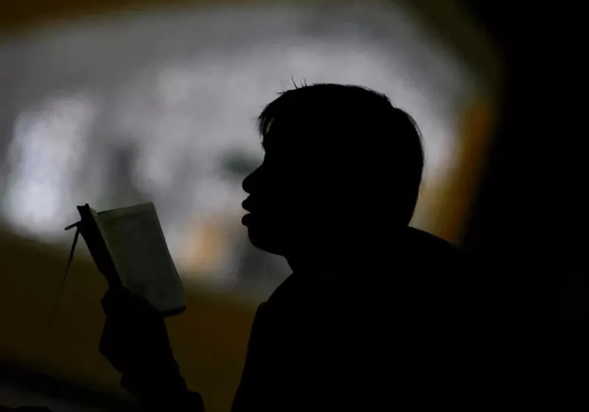 Seorang warga Bandung sedang membaca Alquran. (Sumber: Ayobandung.id | Foto: Irfan Al-Faritsi)