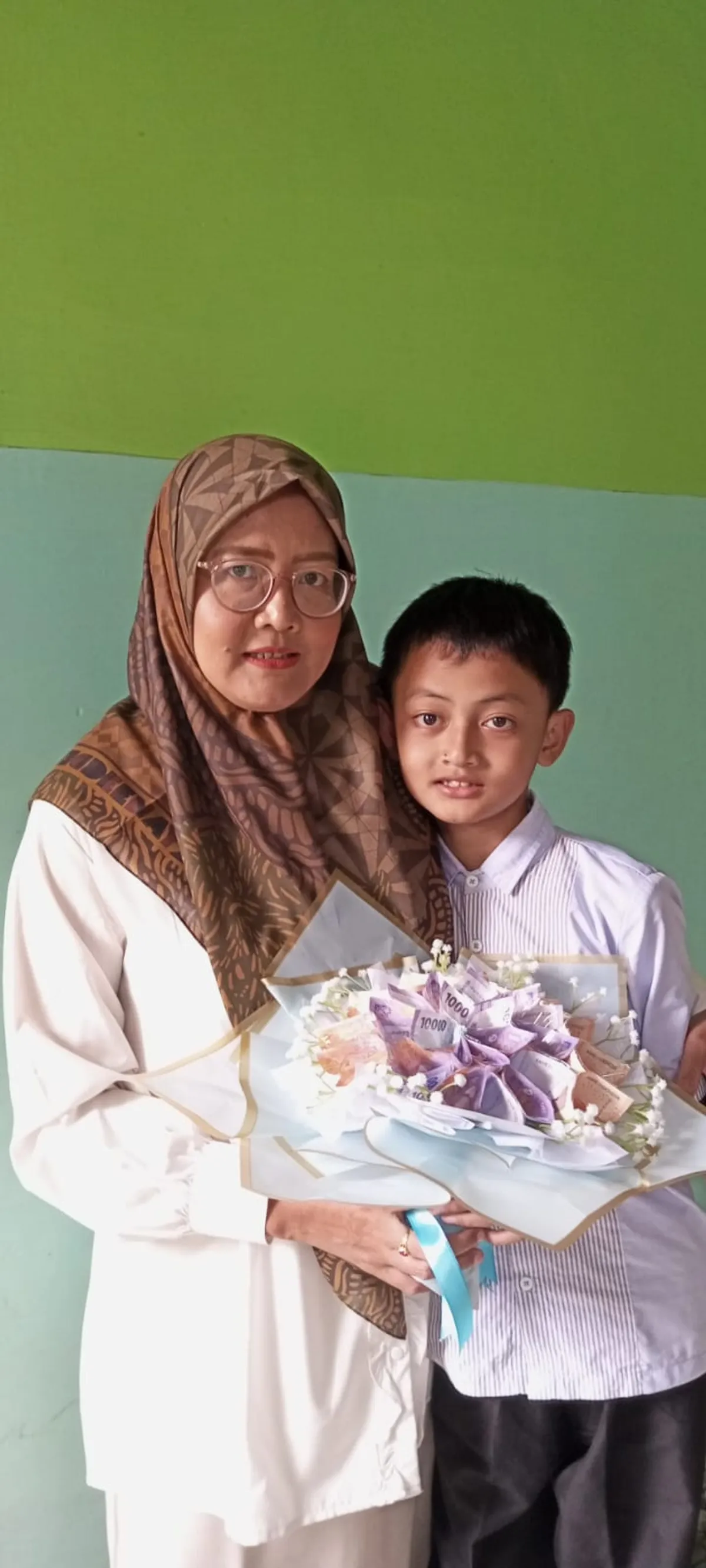 Sebelum melangkah menuju Kampung Kawangi, istri menghadiahkan sebuket bunga kepada Aa Akil, mengiringi perjalanan dengan kasih dan doa. (Sumber: Istimewa | Foto: Kaka Fia)