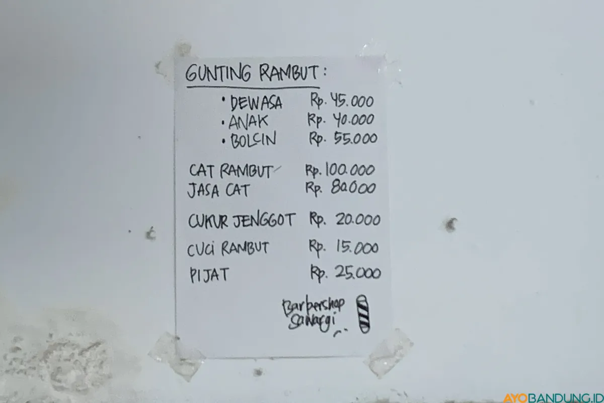 Daftar tarif cukur di selembar kertas karton terpajang di Barbershop Sawargi. (Sumber: ayobandung.id | Foto: Halwa Raudhatul)