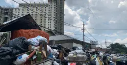Kondisi tumpukan sampah menutupi badan jalan di kawasan Pasar Cicadas pada siang hari, (30/11/2025), sehingga mengganggu aktivitas warga dan pedagang di sekitar lokasi. (Foto: Adinda Jenny A)