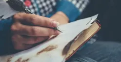 Menulis kosakata arkais pada kertas buku. (Sumber: Pexels/Vika Glitter)