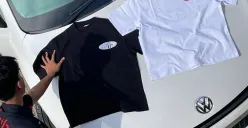 Tim urbodycount menata koleksi kaos edisi terbaru di atas mobil sebagai bagian dari proses pemotretan produk di Buahbatu Square Jl.Apel 1 NO.18, Bandung, Jawa Barat, Selasa (4/11/2025) (Sumber: Rahma Dewi | Foto: Rahma Dewi)