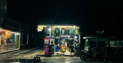 Kios distro Dimas Angga menawarkan berbagai pakaian dan aksesori bergaya streetwear di pinggir jalan kawasan Pasar
Ciwastra pada malam hari di Kota Bandung (4/11/2025). (Sumber: Tito Andrean | Foto: Tito Andrean)