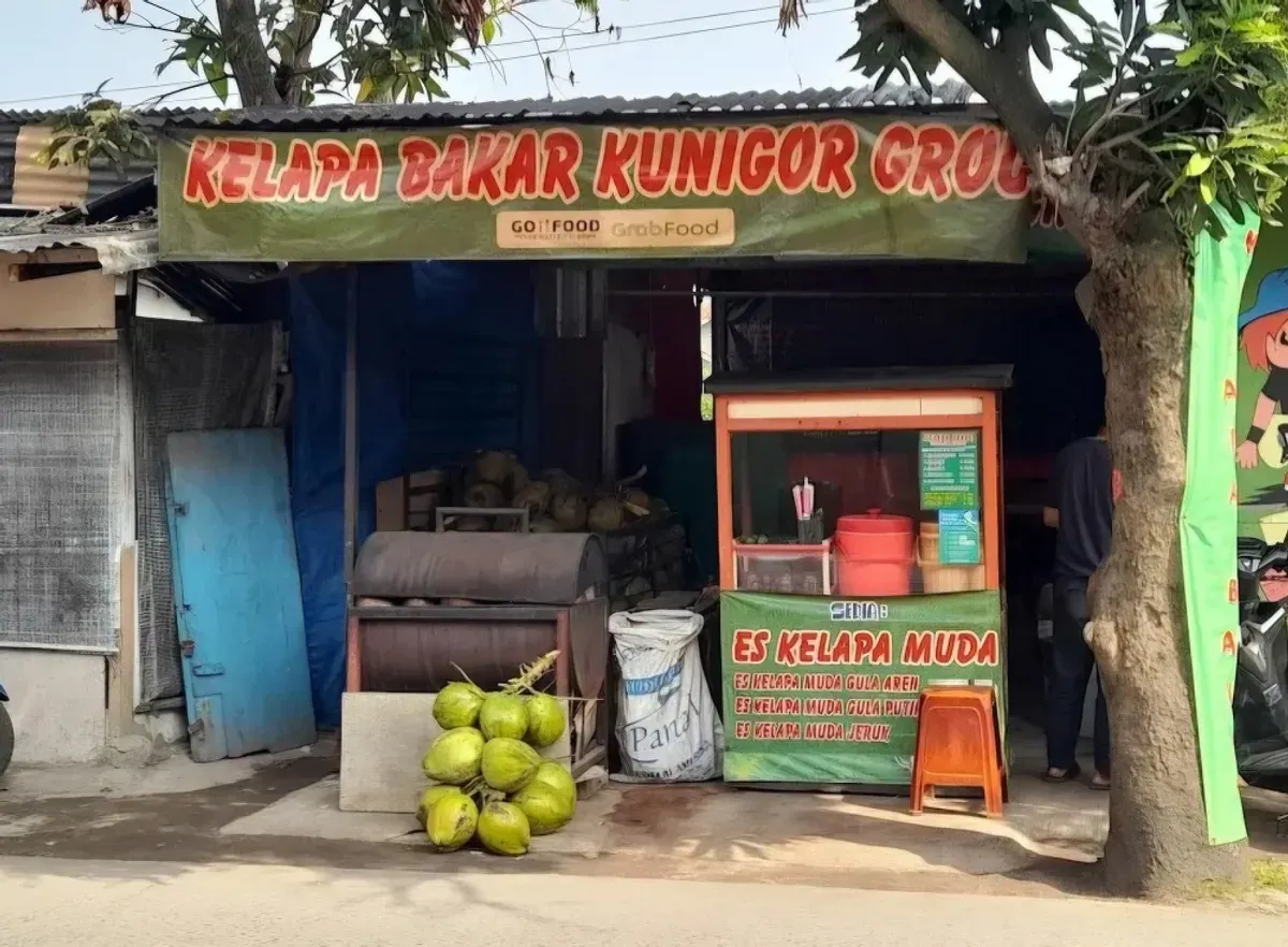 Kedai Kelapa Bakar Kunigor berdiri tanpa hiasan megah, namun membawa kisah cinta dan ketekunan dalam mengangkat kuliner tradisional yang nyaris terlupakan.