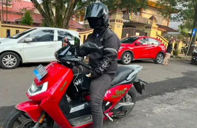 Yusuf dan motor listriknya yang digunakannya untuk mengantar penumpang di kawasan Kota Bandung. (Sumber: ayobandung.id | Foto: Ilham Maulana)